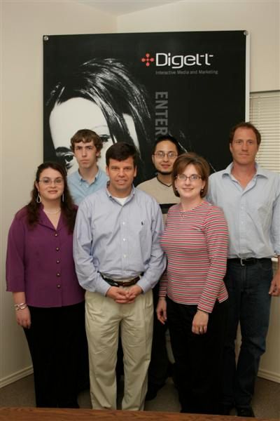 Early Digett team group photo in front of company banner