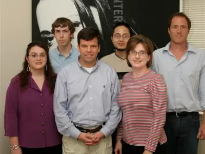 Early Digett team group photo in front of company banner