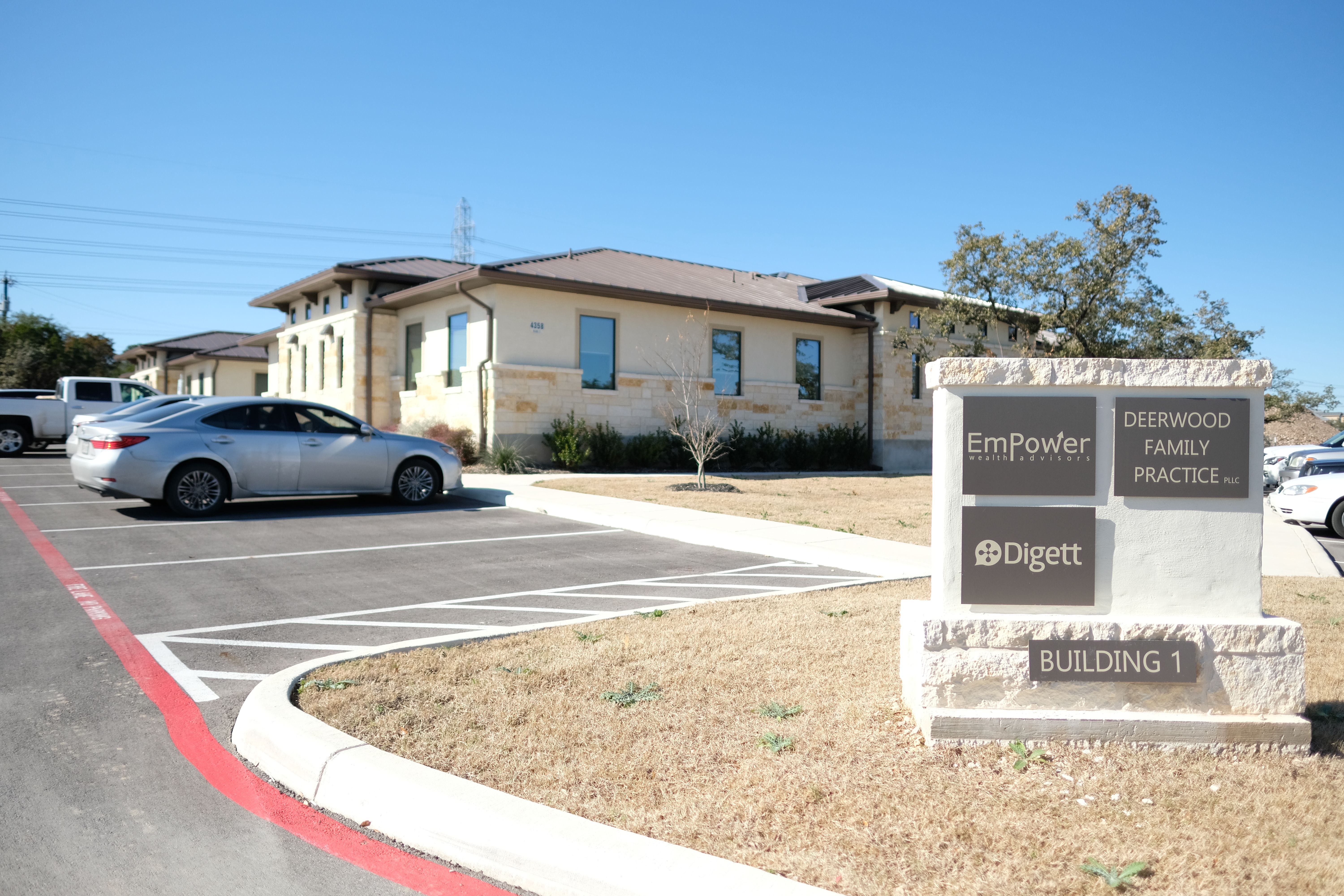 Digett office building exterior with limestone facade and company sign