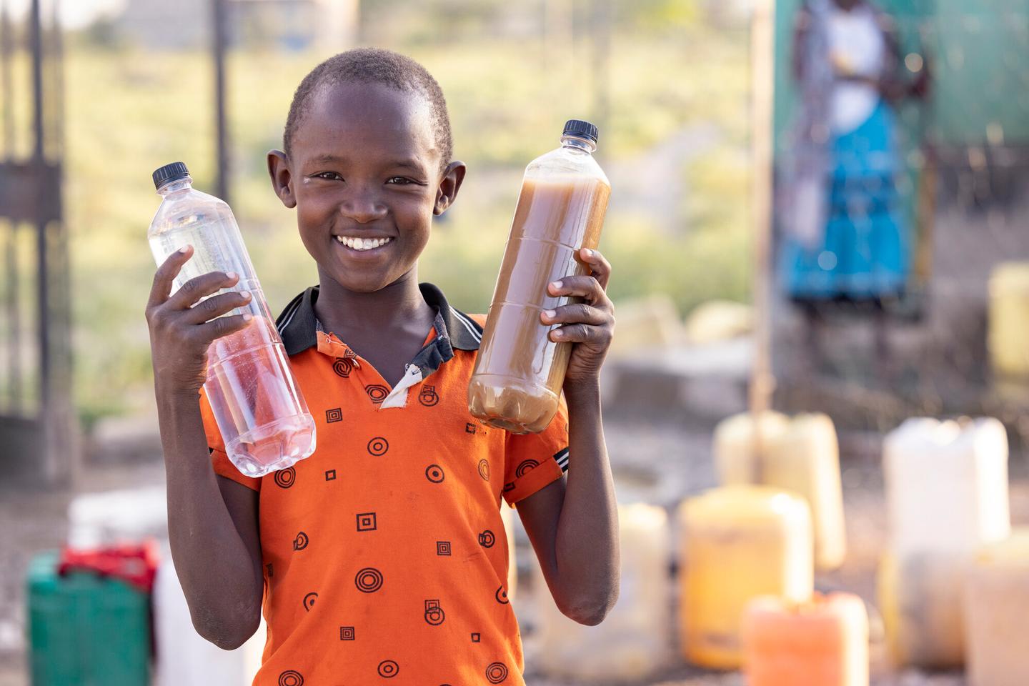 Child holding water bottles