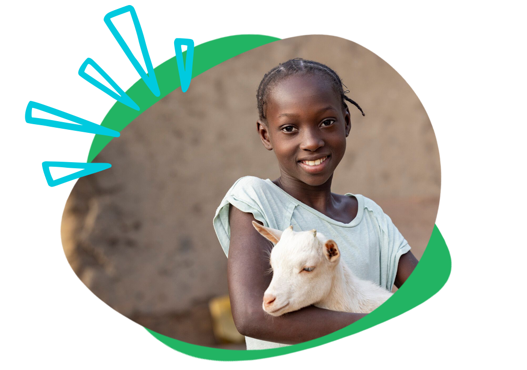 child holding goat in kenya