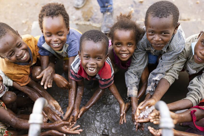 children washing hands and laughing