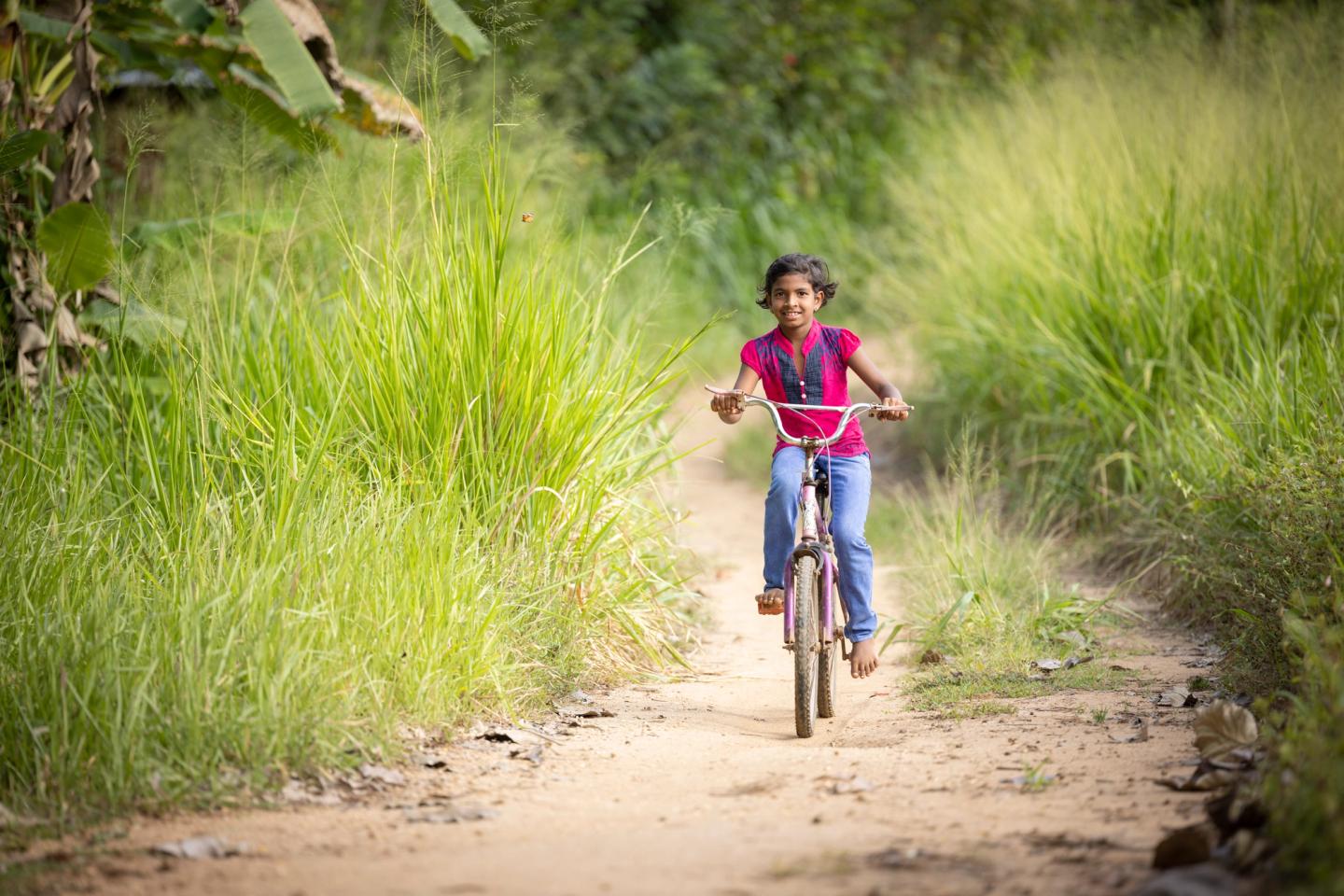 Child riding bike in sri lanka