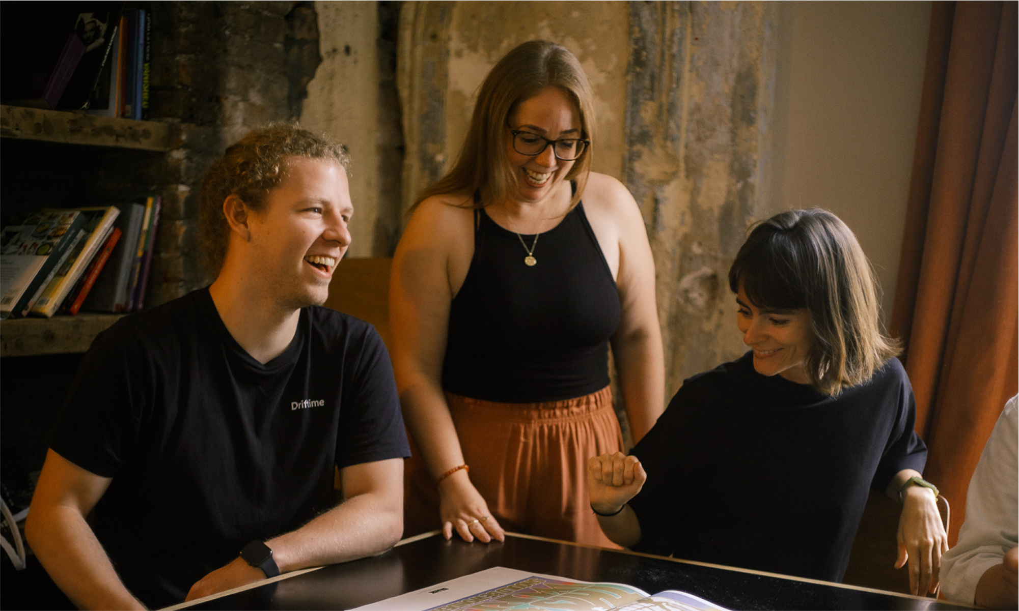 Ed, Jo, and Olivia enjoying the contents of a magazine.