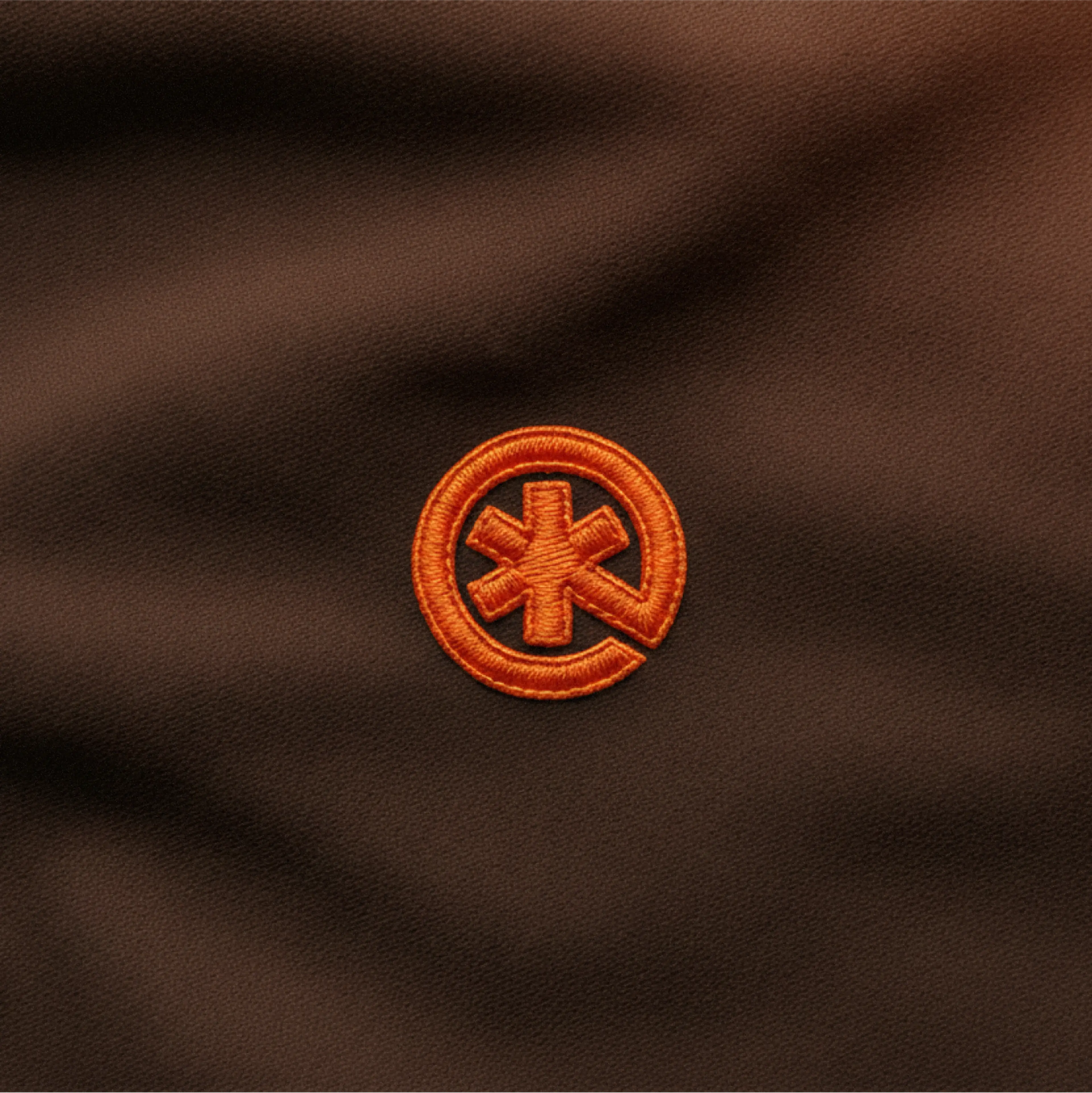 Instant Aid logo embroidered on fabric