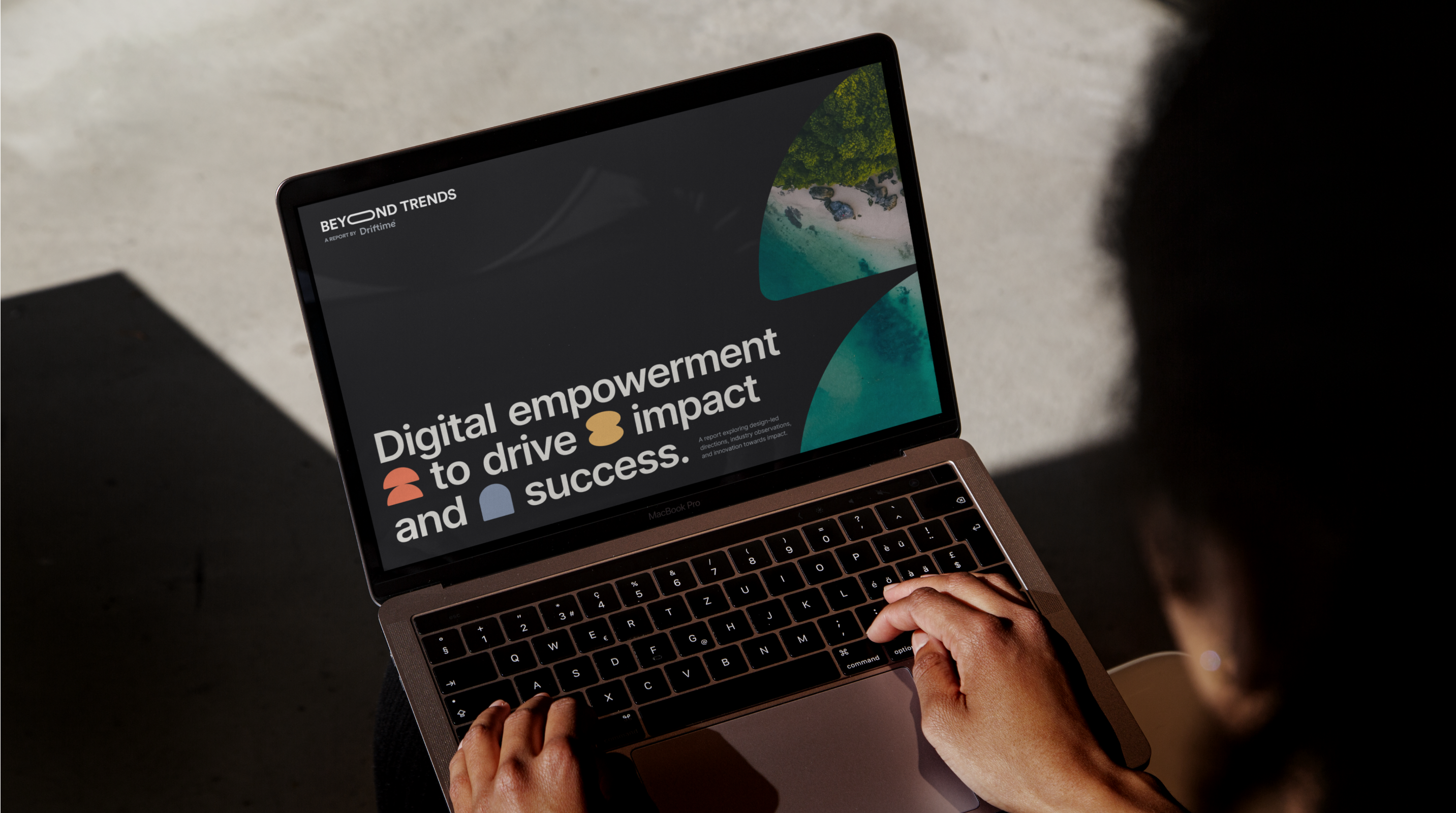 A person on a laptop viewing Driftime's Beyond Trends report