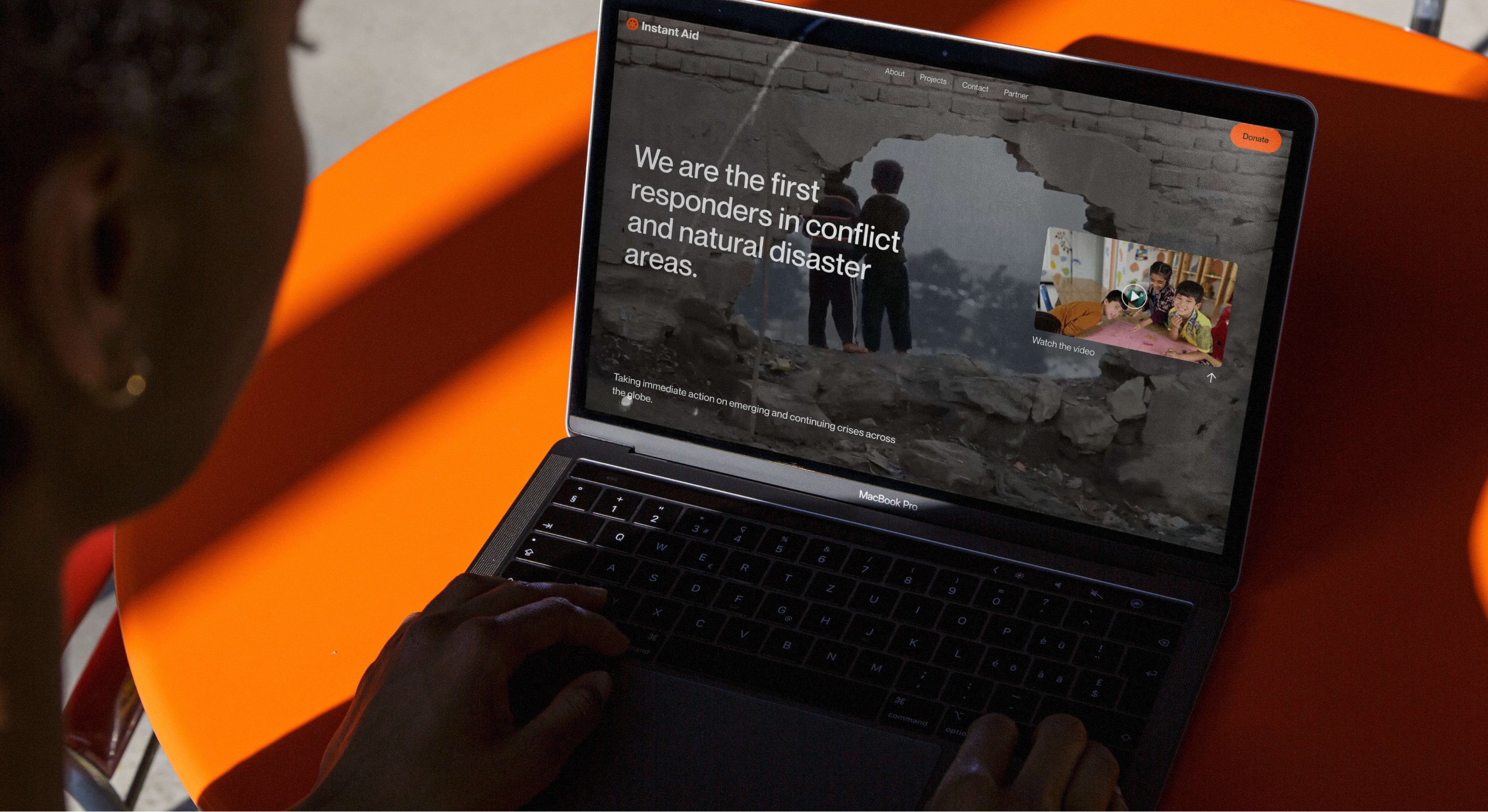 Instant Aid website shown on a laptop