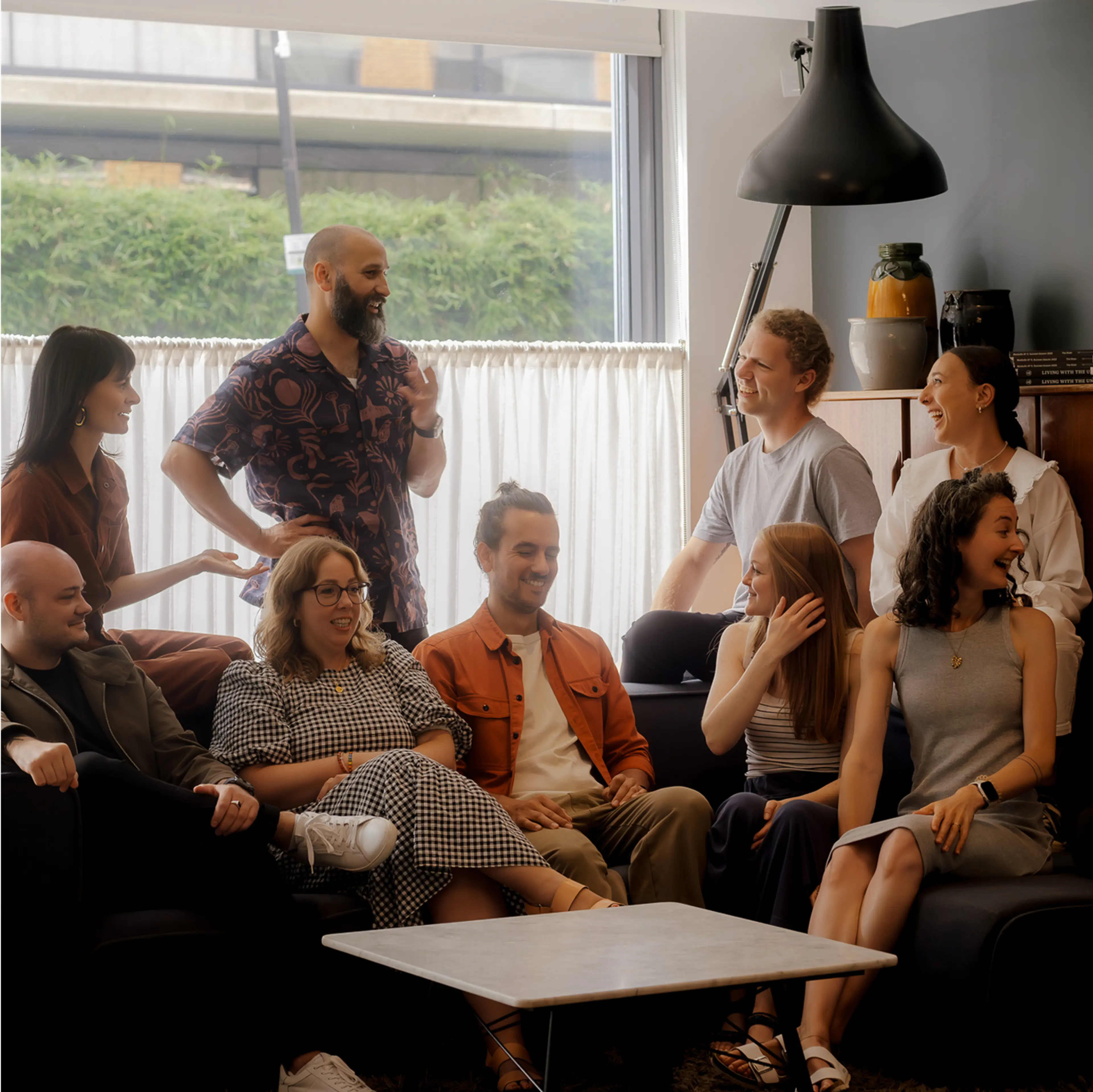 The Driftime team sat on a sofa, laughing and chatting together.