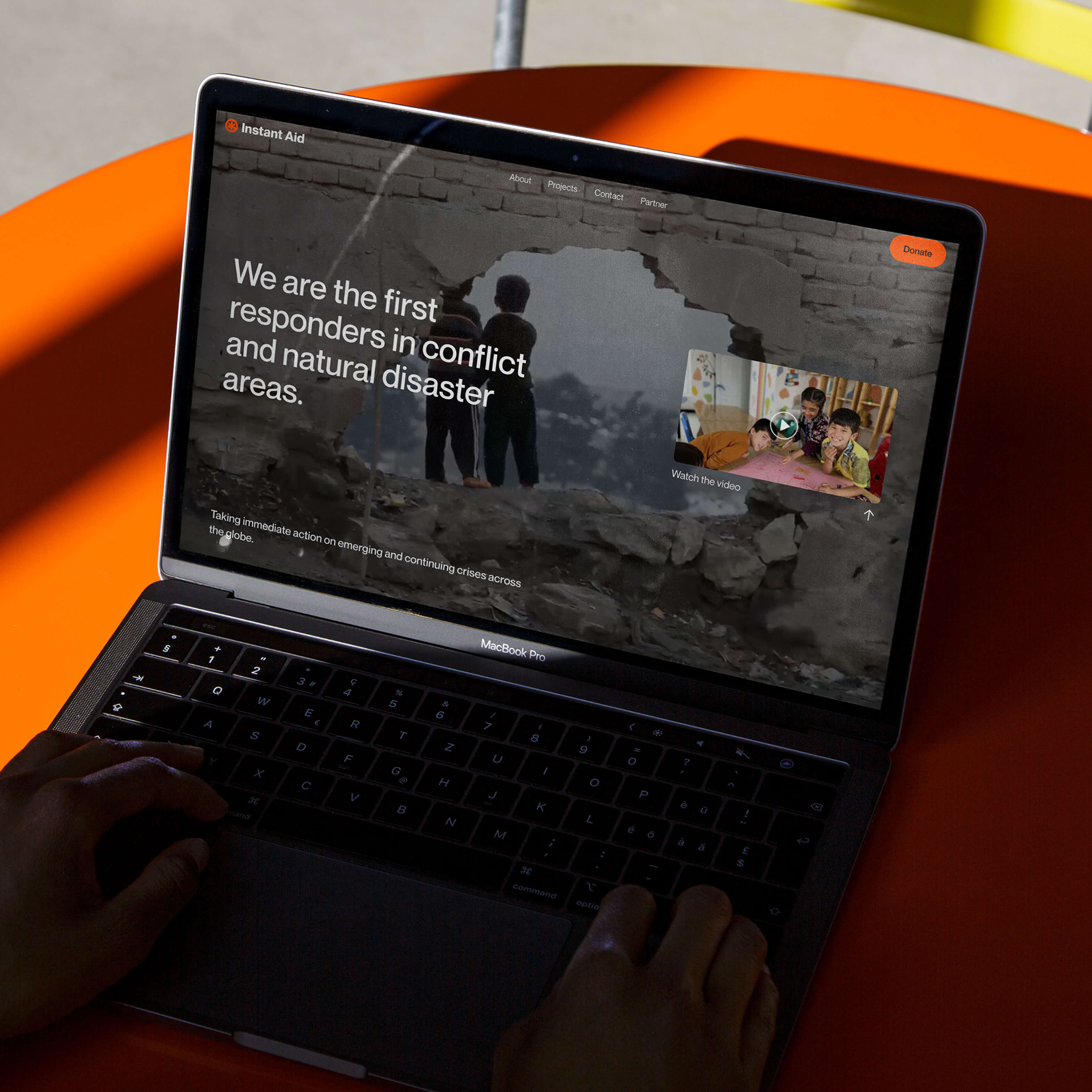 Instant Aid website shown on a laptop