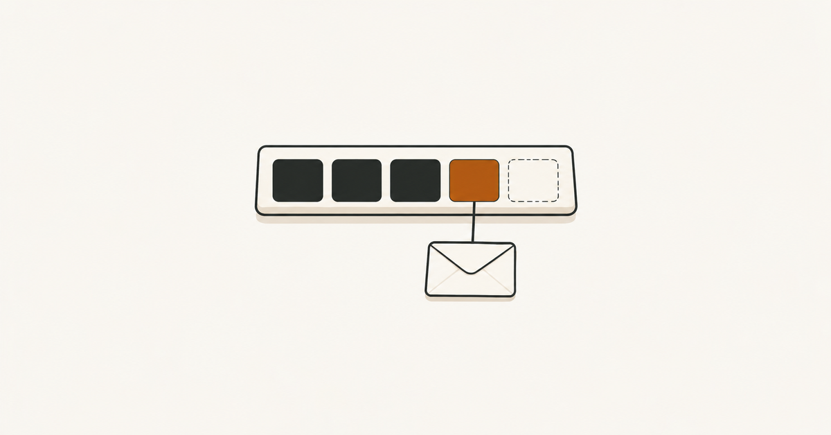A shallow tray with dark and orange tiles and an empty outlined space, above a small envelope.