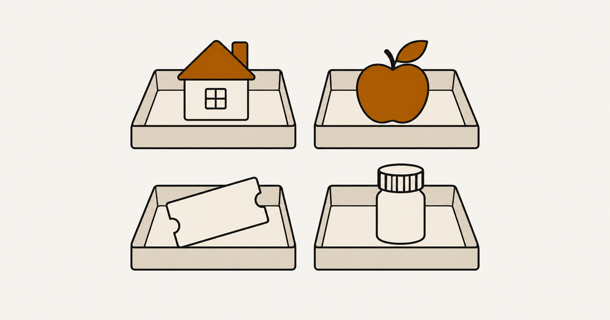 Shallow sorting trays holding a house tile, an apple, a ticket and a medicine bottle.