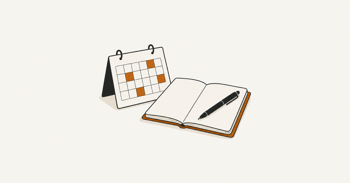 Calendar beside an open notebook and pen.