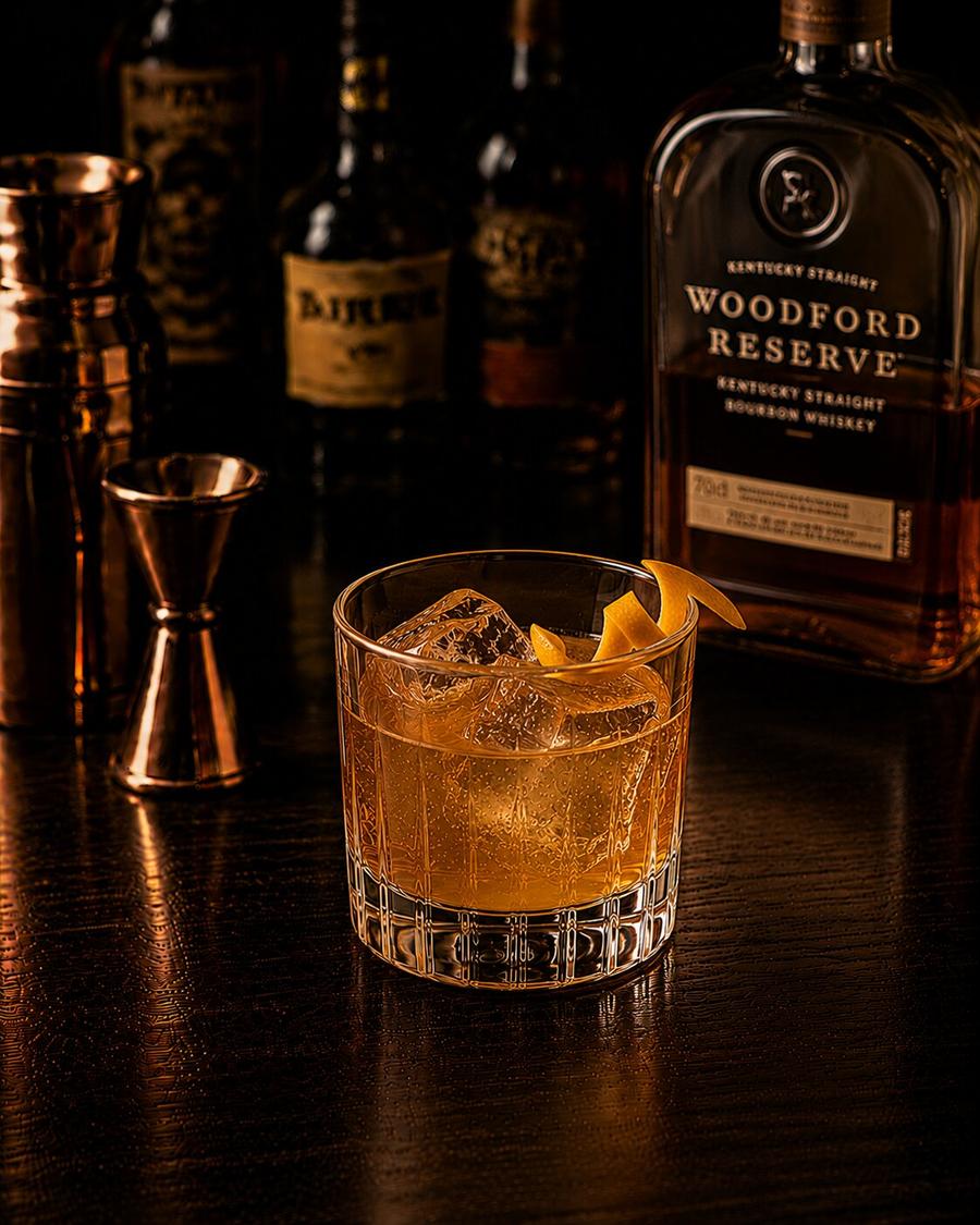 Gold Rush drink in rocks glass with orange peel garnish