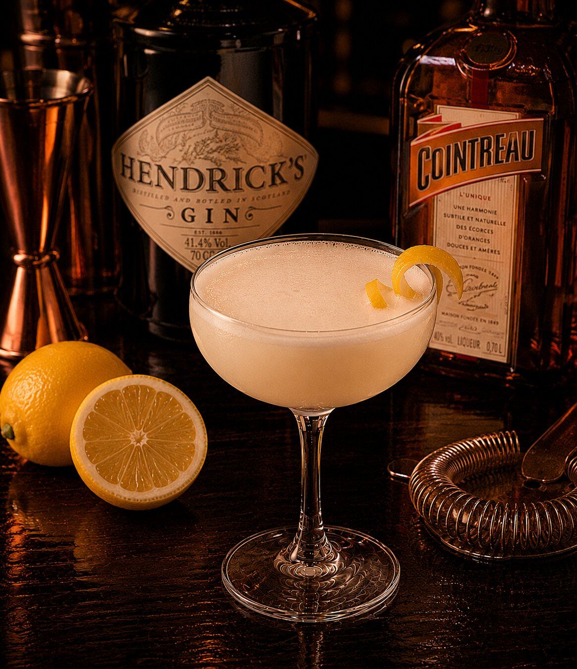 White lady drink with lemon peel wedge