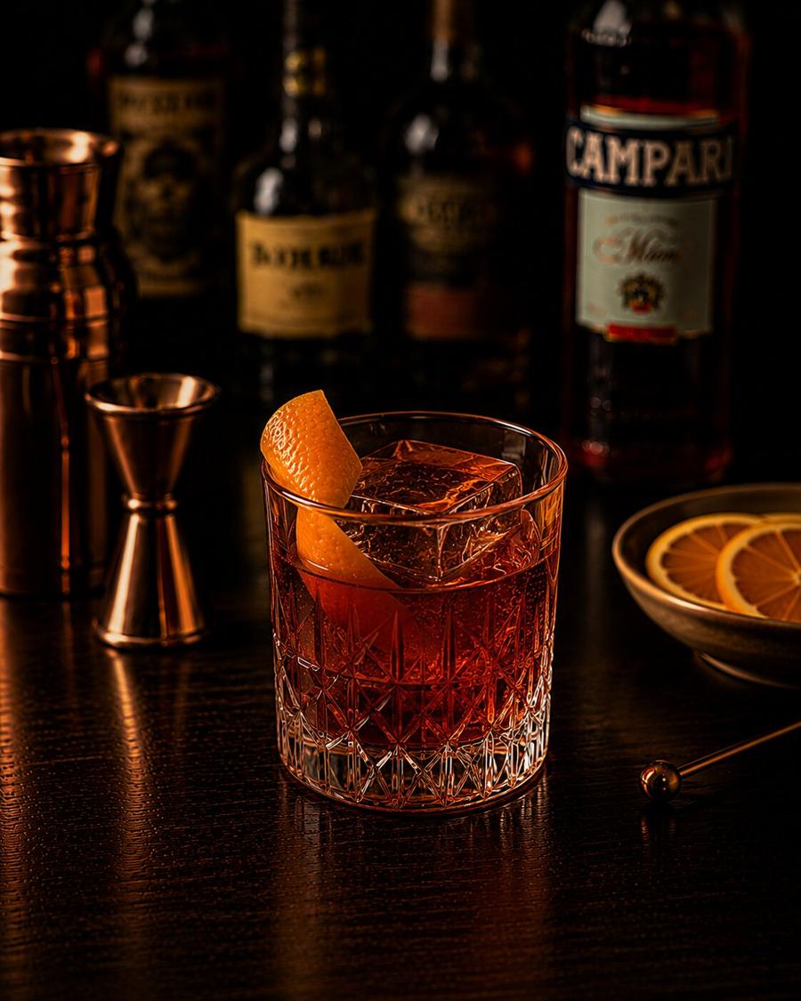 Boulevardier drink in rocks glass with orange wedge