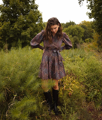 Model in Dress, The Countryside Poplin Tiered Shirtdress - Floral Prairie in Chocolate (Brown with Pink, Blue and Yellow Floral Print)