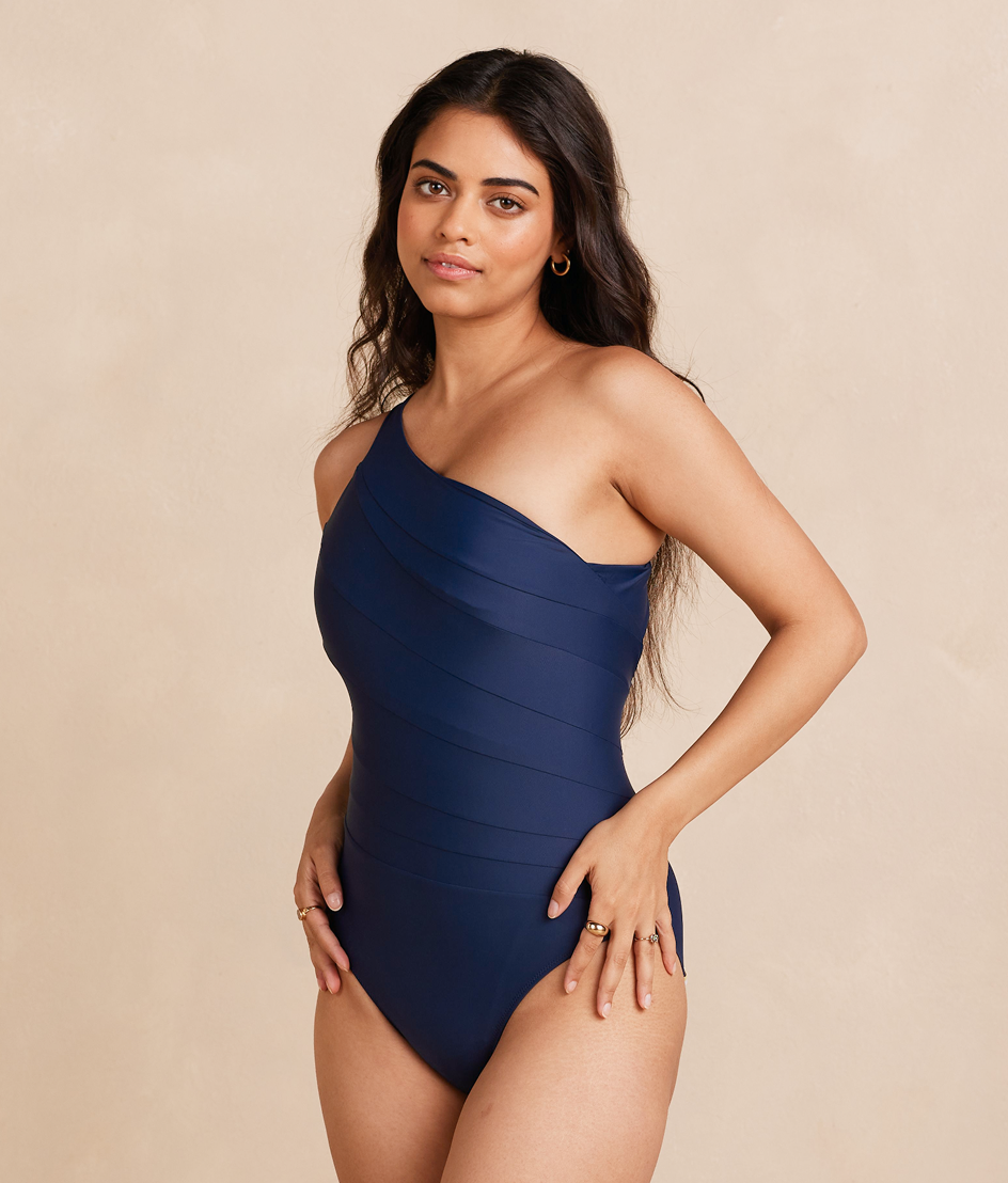 Model in black and white one piece swimsuit