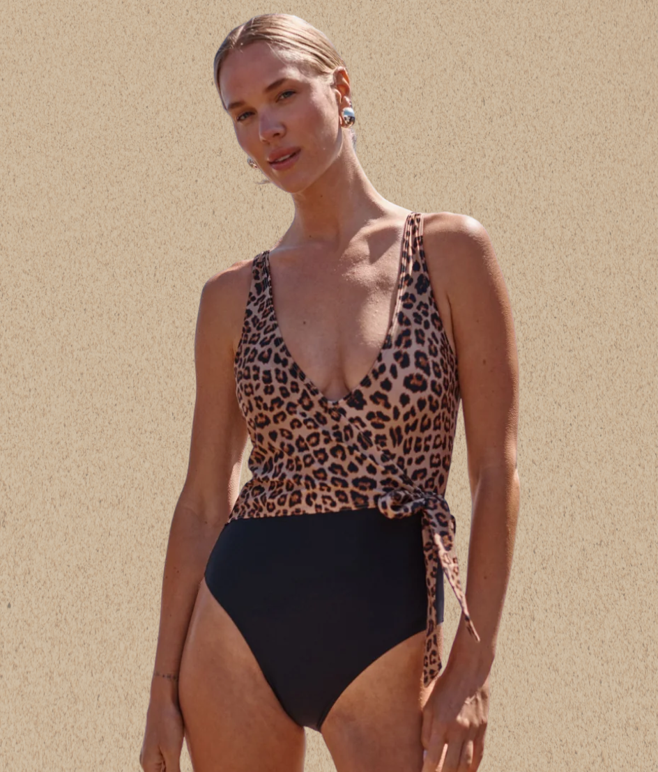 Model in black one piece swimsuit