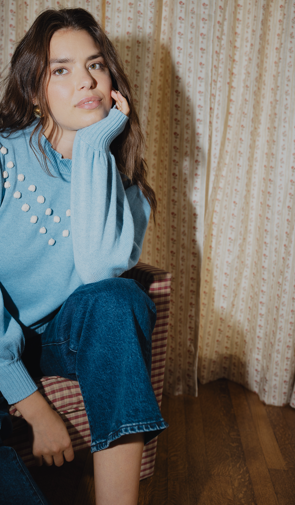 Model in blue cashmere sweater and denim