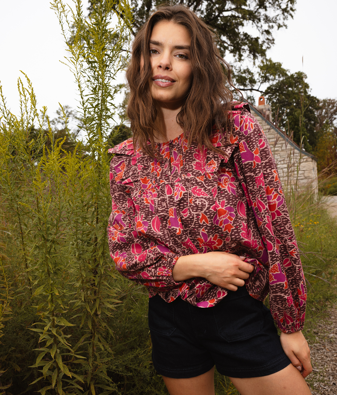 Tees & Tops: Model in Ruffle Blouse - The Countryside Poplin Ruffle Blouse - Vineyard Blooms in Pinot (red and brown floral print)