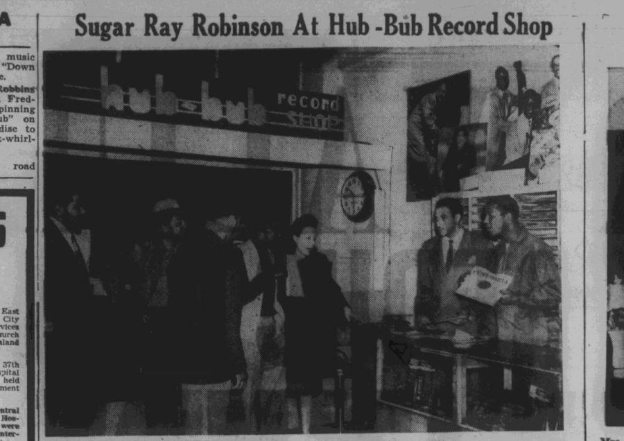Newspaper headline with photo in record shoP: Sugar Ray Robinson At Hub-Hub Record Shop