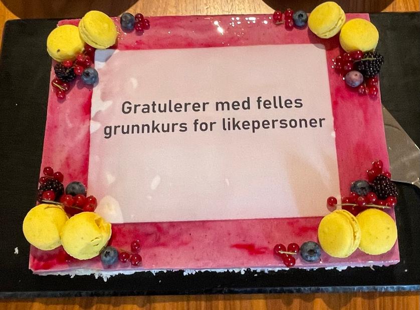 Rosa kake med teksten "Gratulerer med felles grunnkurs for likepersoner"