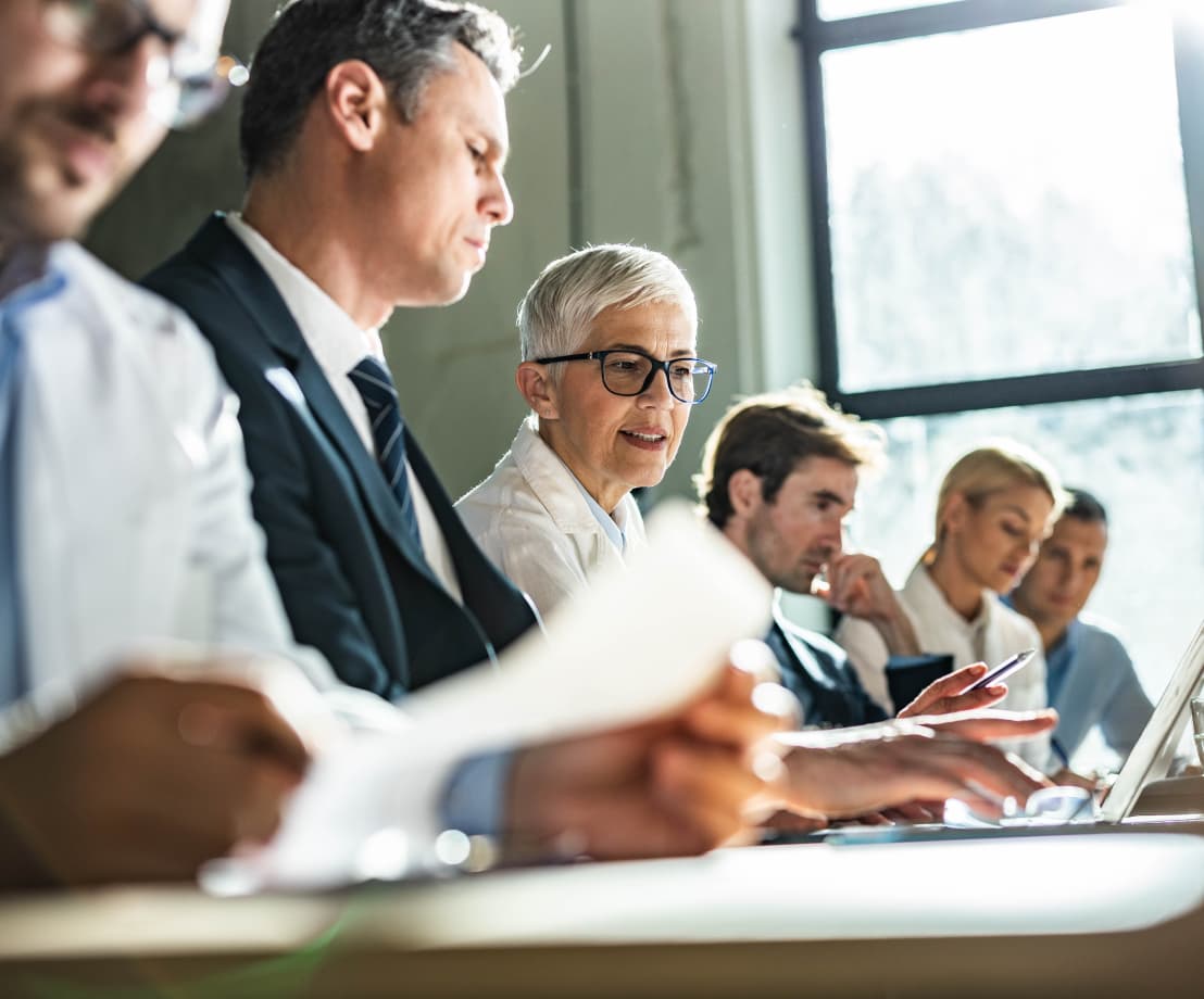 People at a desk reviewing documents together