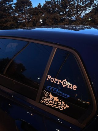 FORRONE and crew stickers on a car window at dusk