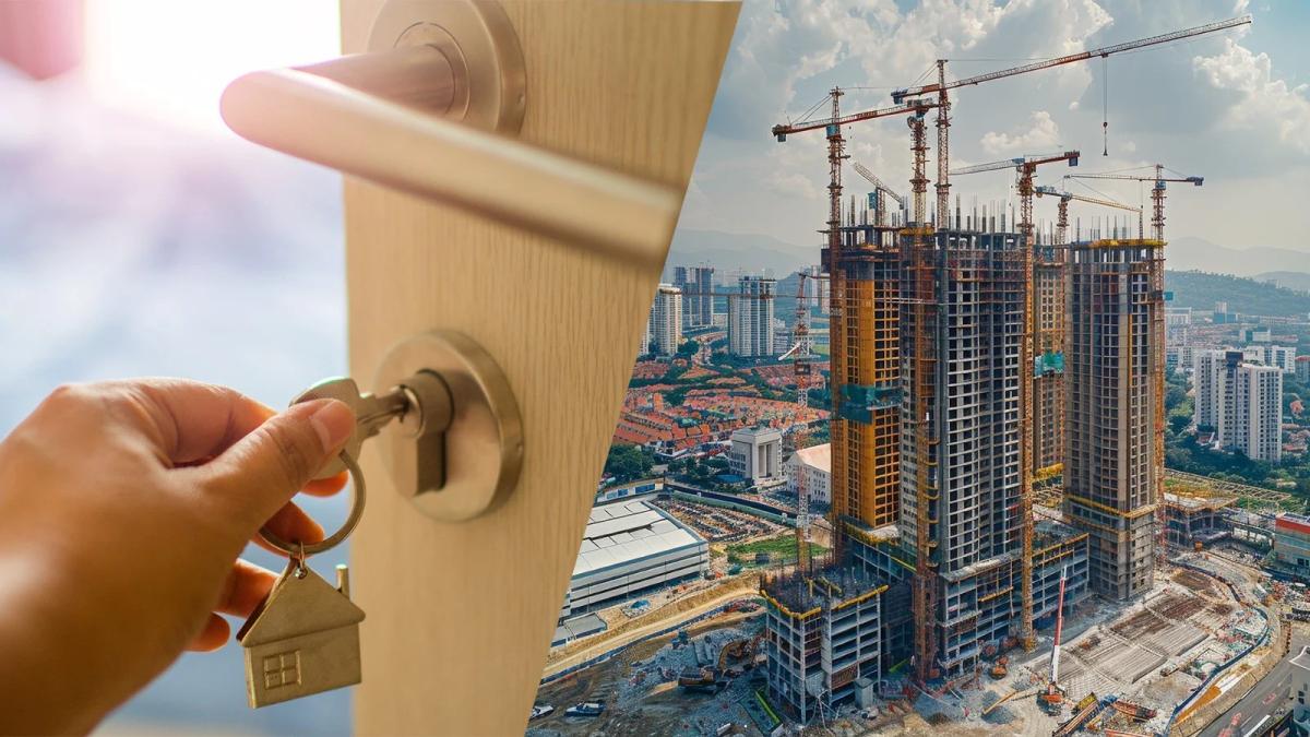 Hand holding a house key at a door alongside a high-rise building under construction, representing ready-to-move-in property expectations.