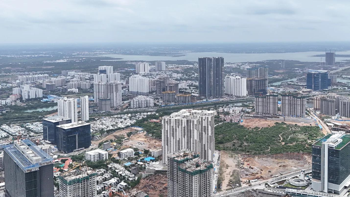 Aerial view of Hyderabad’s urban skyline with high-rise residential and commercial developments under construction.