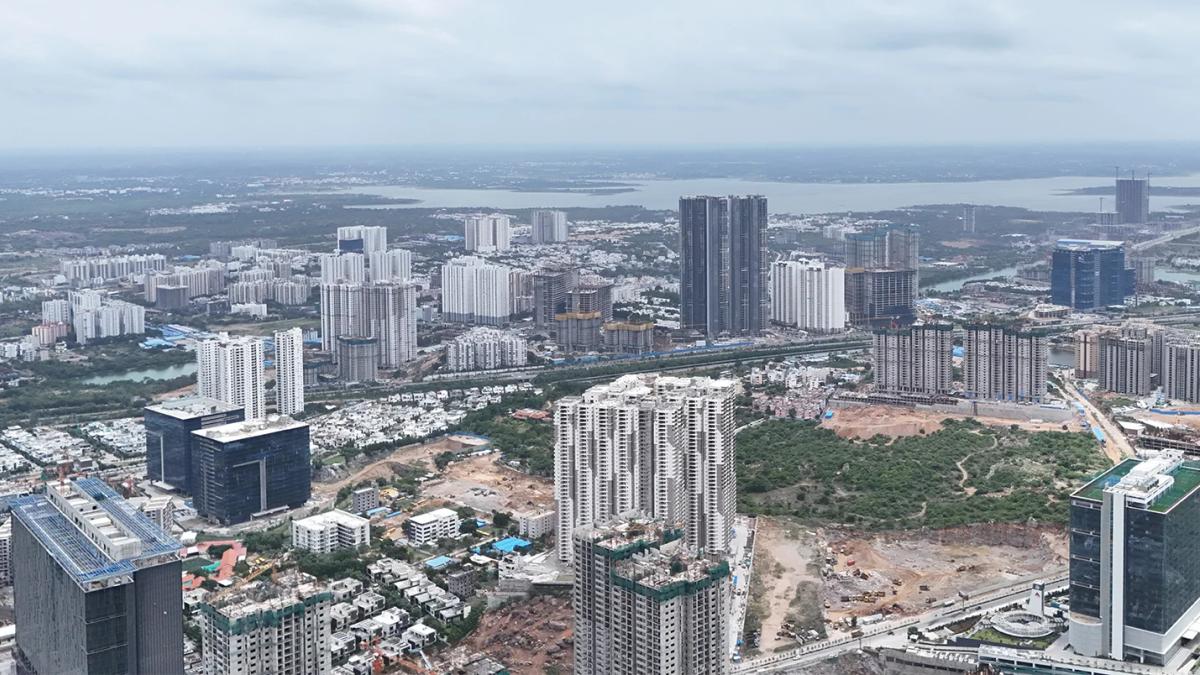 Aerial view of Hyderabad’s urban skyline with high-rise residential and commercial developments under construction.