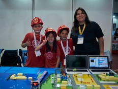 Photograph of students and their teacher presenting the Alerted by the River! prototype.