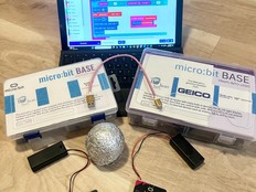 Image shows a computer with project code and two micro:bits.