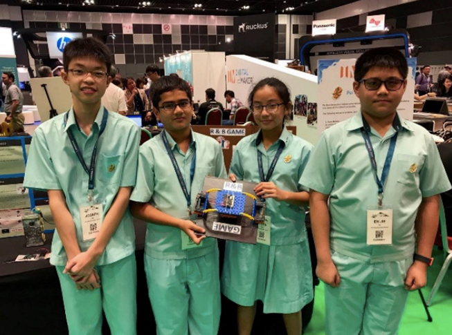Four students showcasing an invention