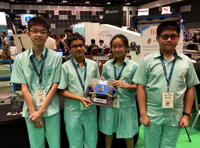 Four students showcasing an invention