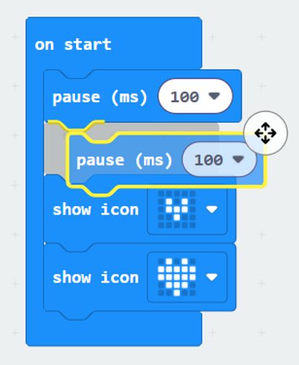 A MakeCode program with a pause block in move mode, ready to be moved by the arrow keys