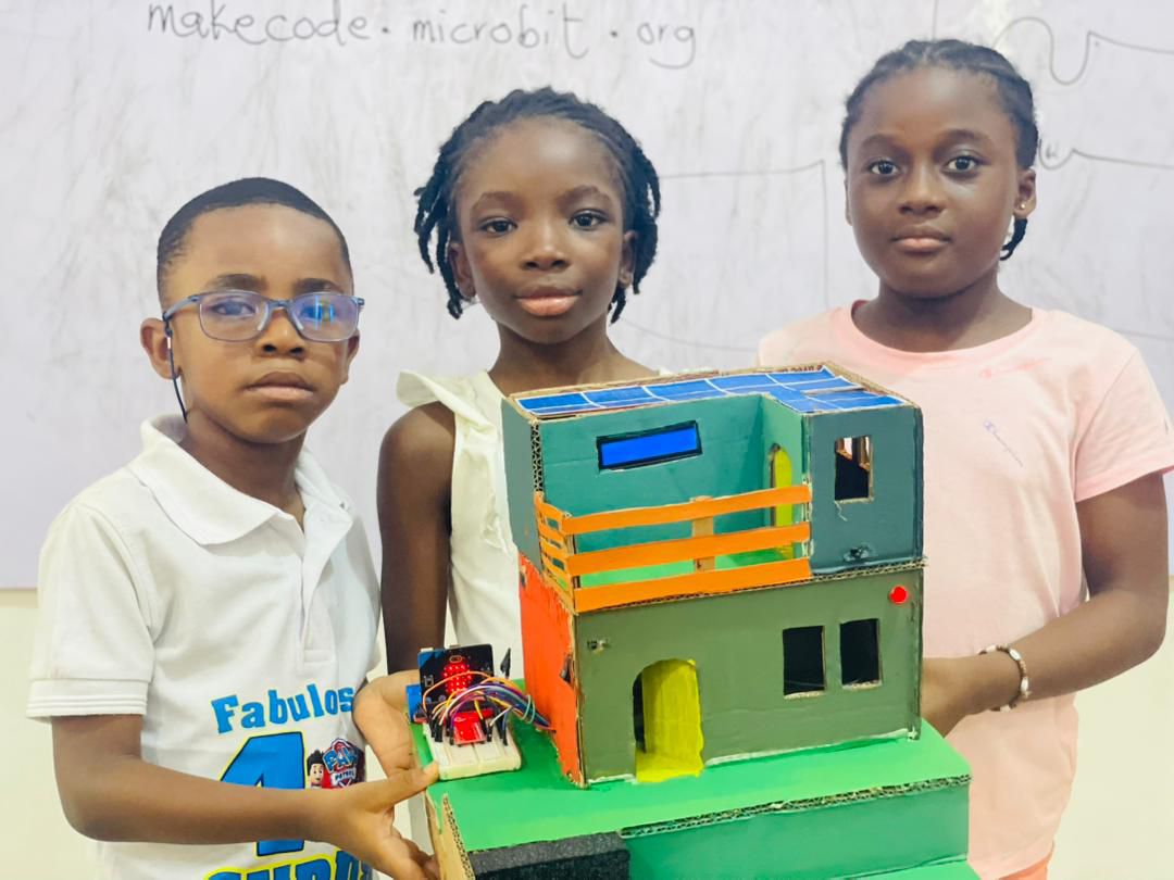 Three students present the project prototype.