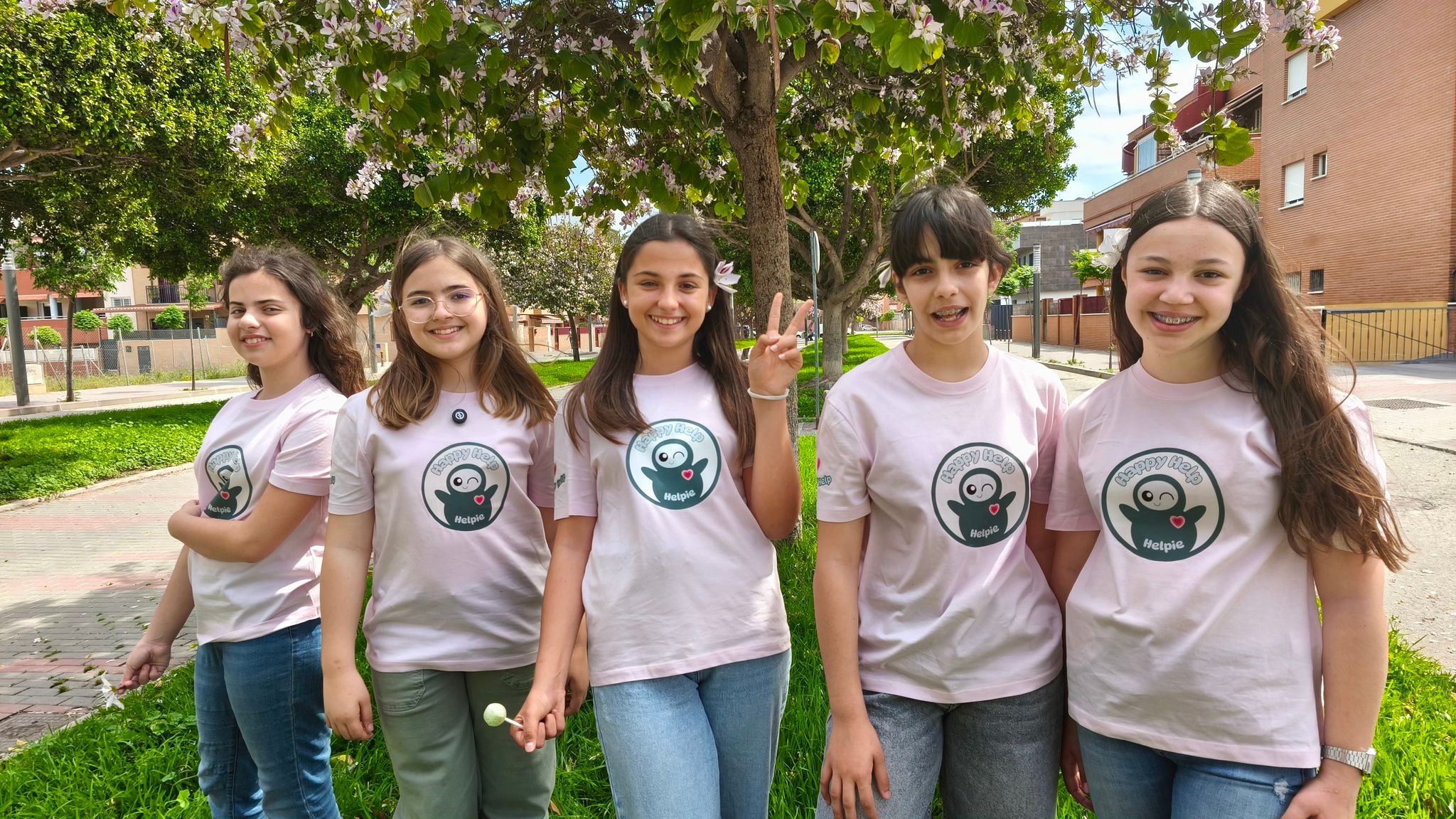 Photo of the students who created Helpie standing outside wearing matching tshirts. 