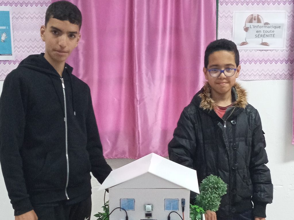 Two winners standing with their smart home creation
