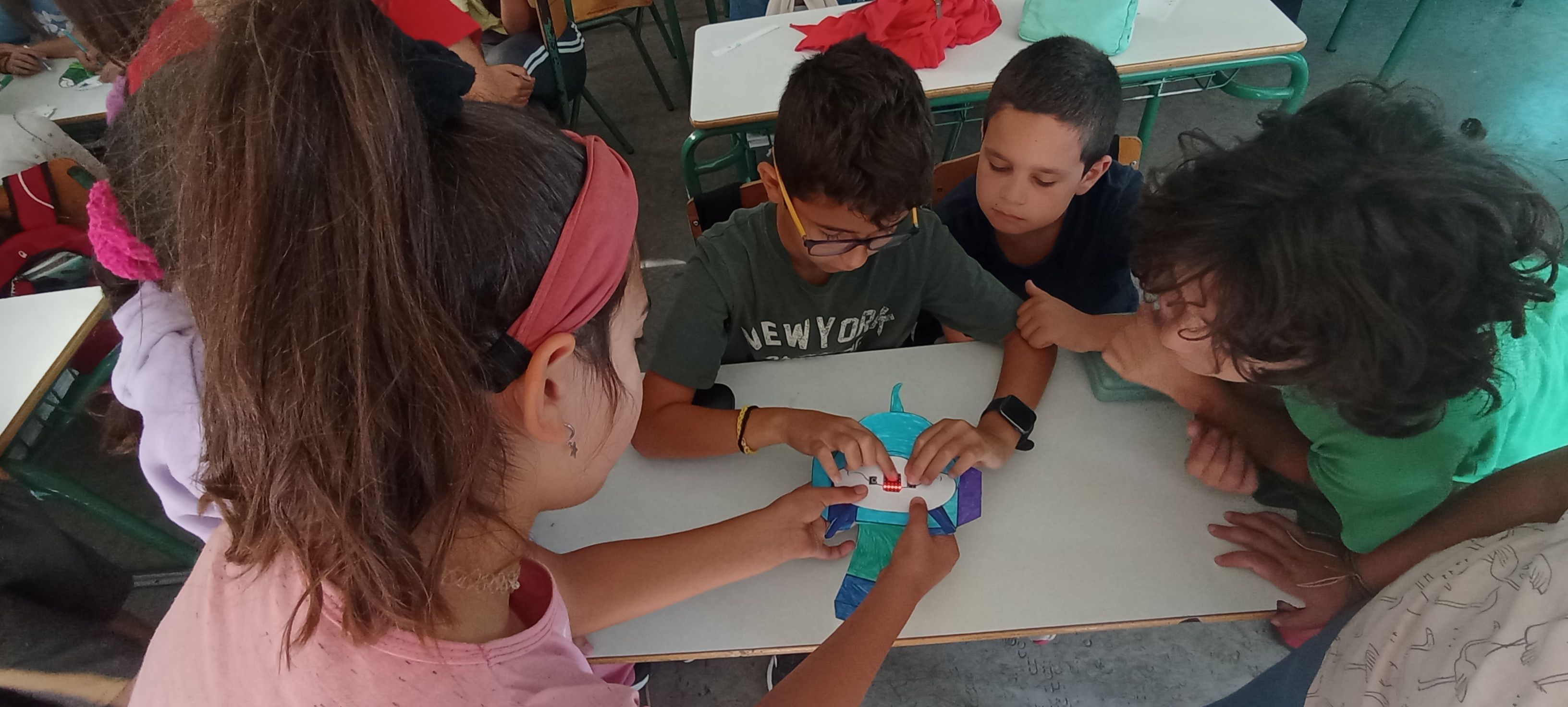 Students working together to build a micro:bit animal.