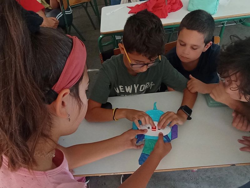 Students working together to build a micro:bit animal.