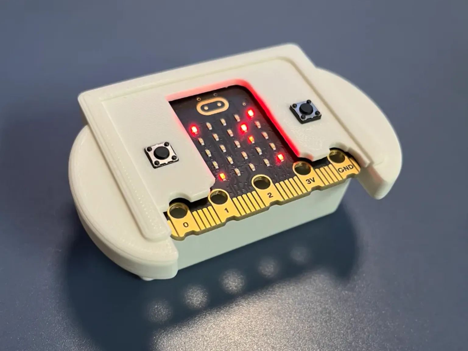 A 3d printed mount for the micro:bit with round edges to fit comfortably between palms of hands.