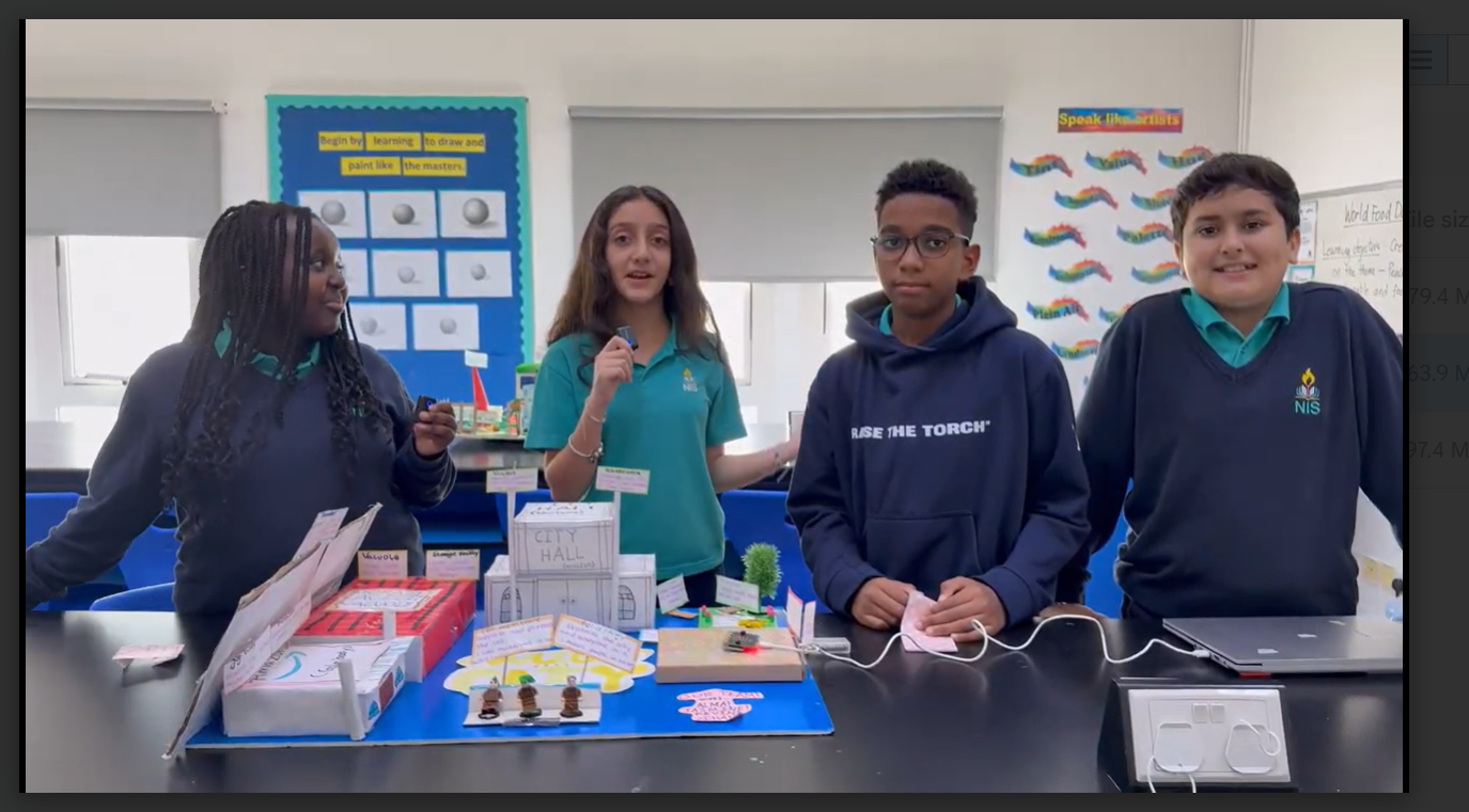 Students present another example of the cell city prototype. 
