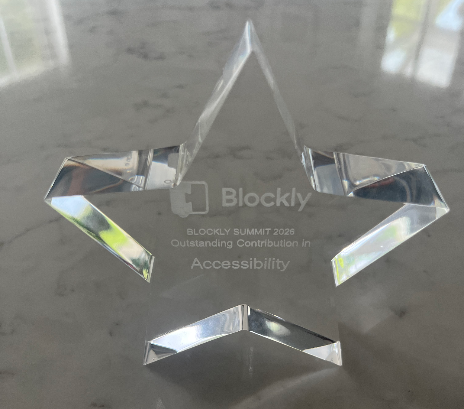 The photograph of the Blockly Summit Accessibility 2026 prize – a star shaped trophy enscribed with Outstanding contribution in accessibility.