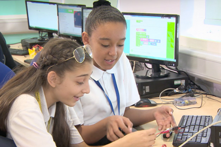 two girls working with micro:bit