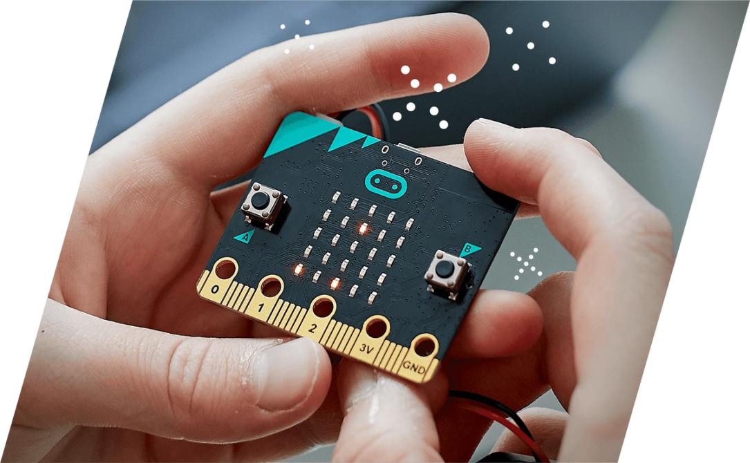 a child's hands holding a BBC micro:bit