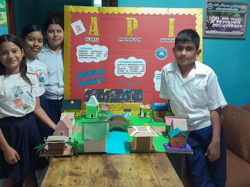 Students pose with the API prototype and project board.