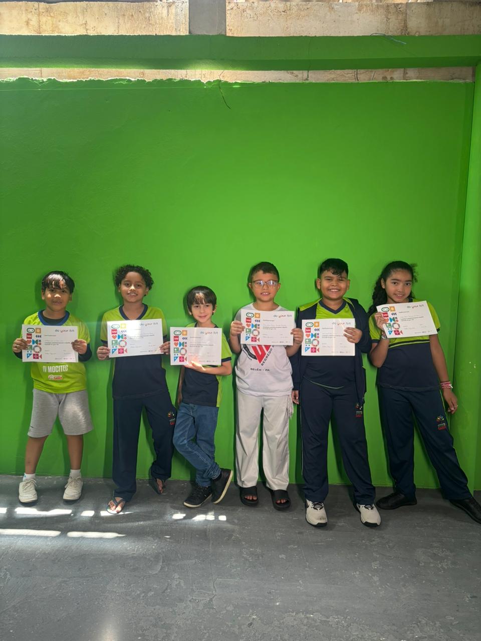 Students pose with certificates for the completion of their project.