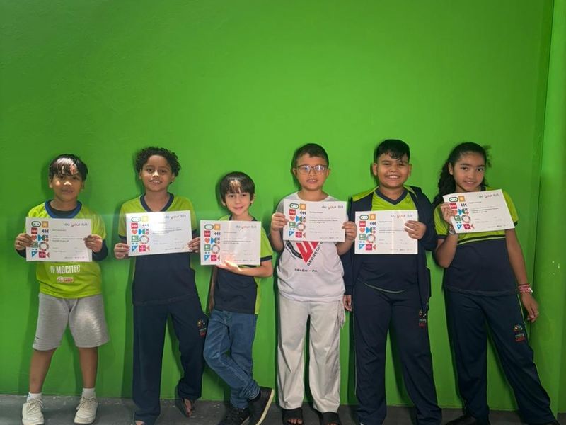 Students pose with certificates for the completion of their project.