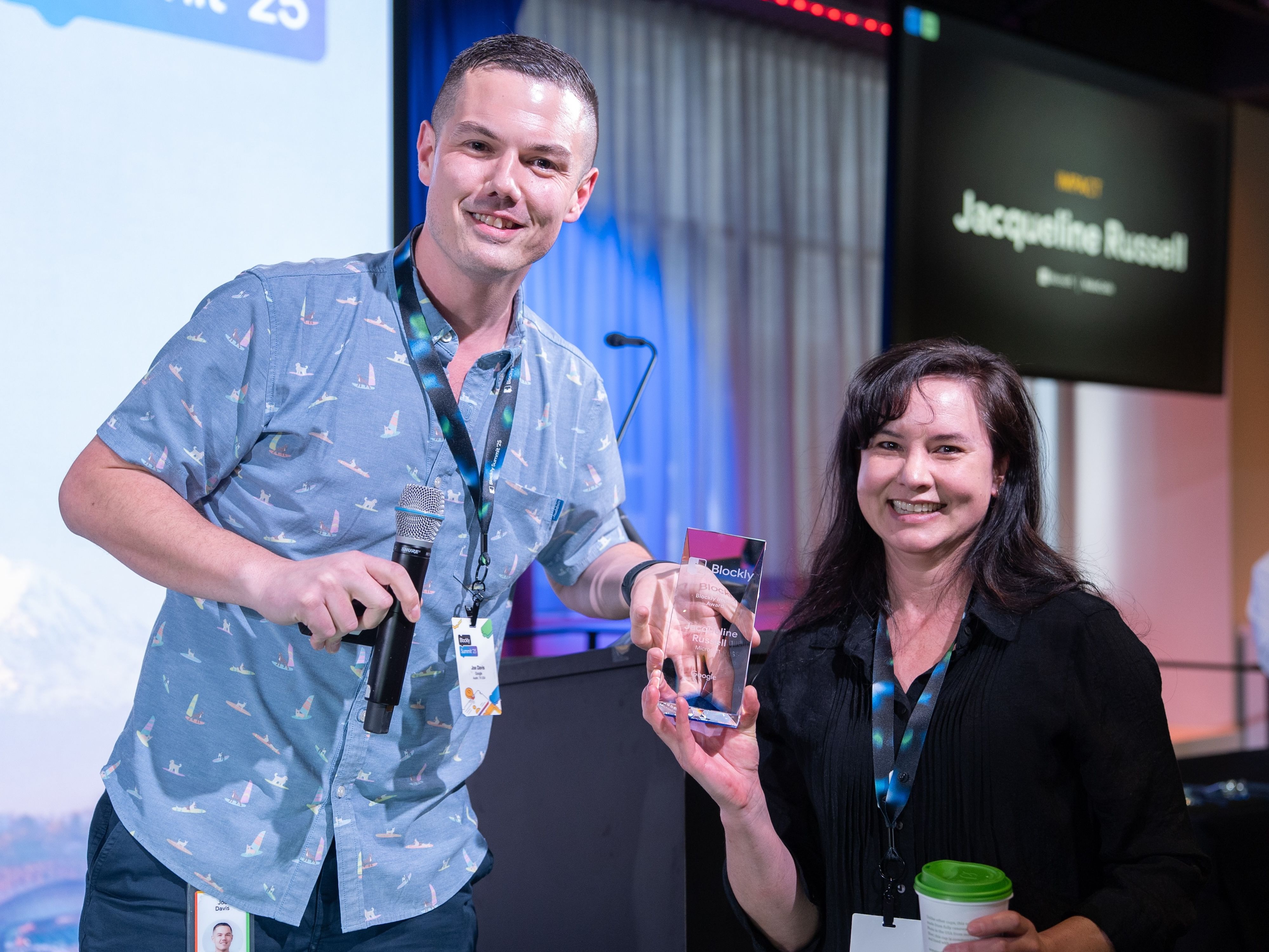 Jacqueline Russell (MakeCode) receiving the Blockly Impact Award from Joe Davis (Google) at the Blockly Summit 2025